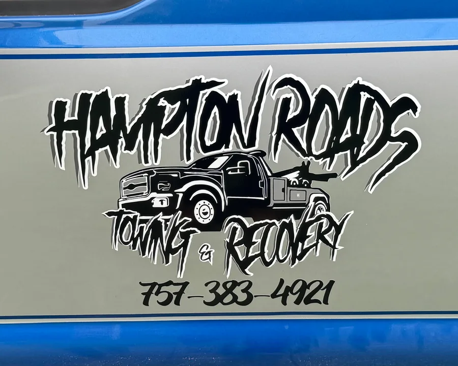 The truck's passenger door: blue over silver, with the Hampton Roads Towing & Recovery logo and 757-383-4921 in black vinyl